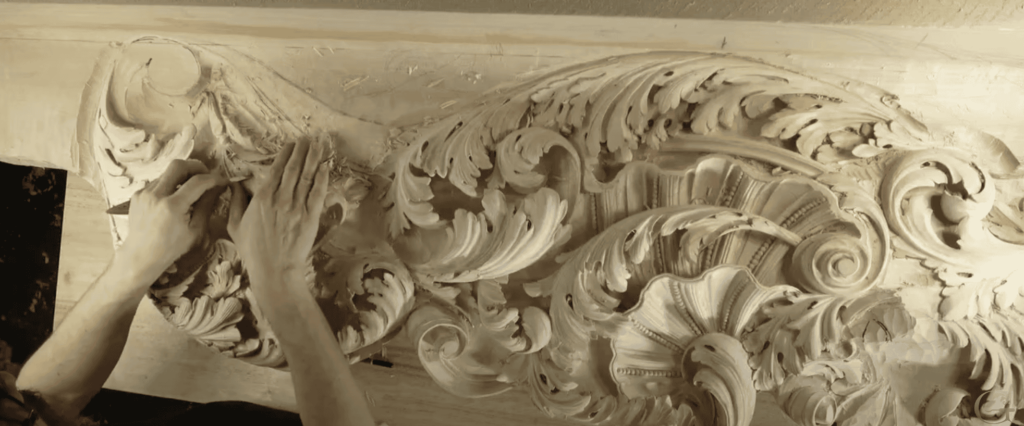 Hands using a carving knife to create intricate wood carving details with floral patterns. Knives- Wood Carving techniques displayed.